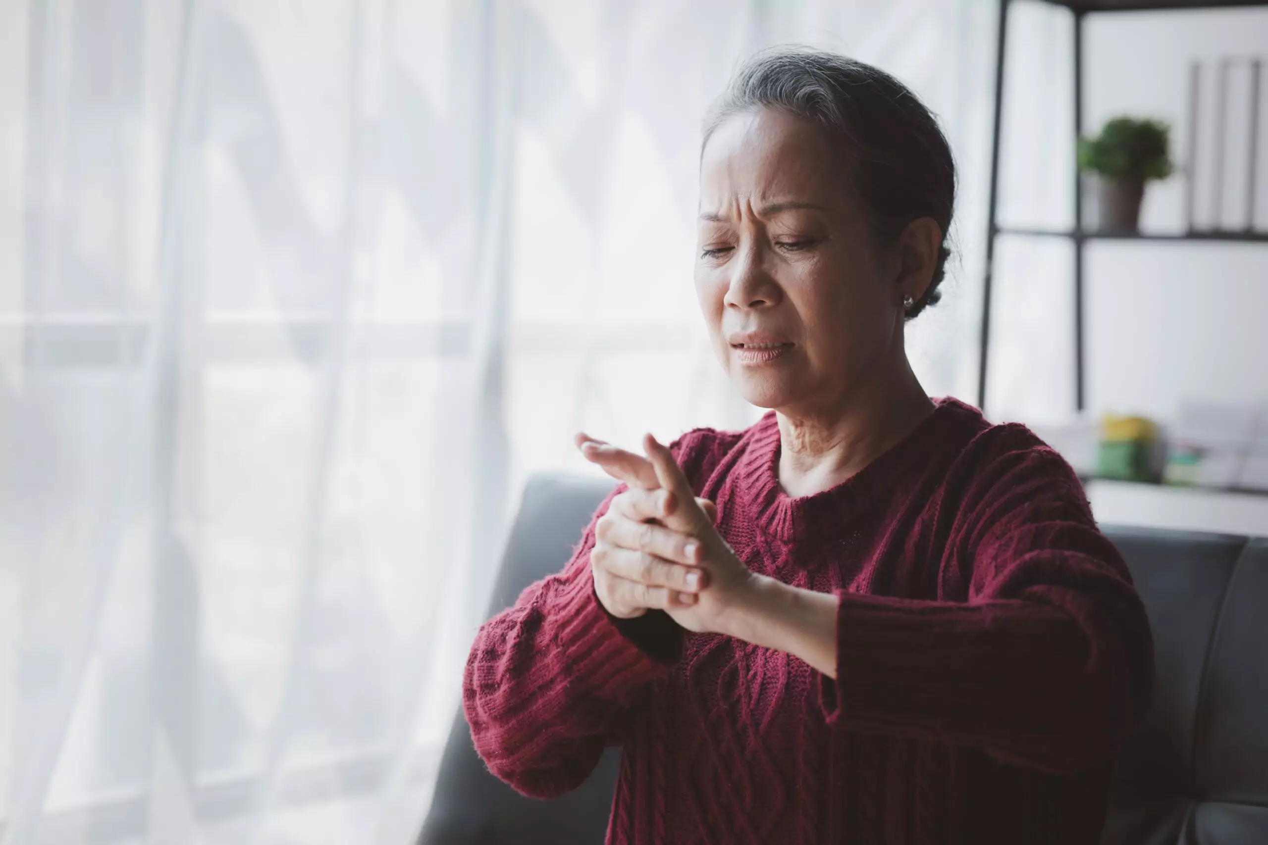senior woman sitting in the living room at home an 2025 01 16 22 32 42 utc