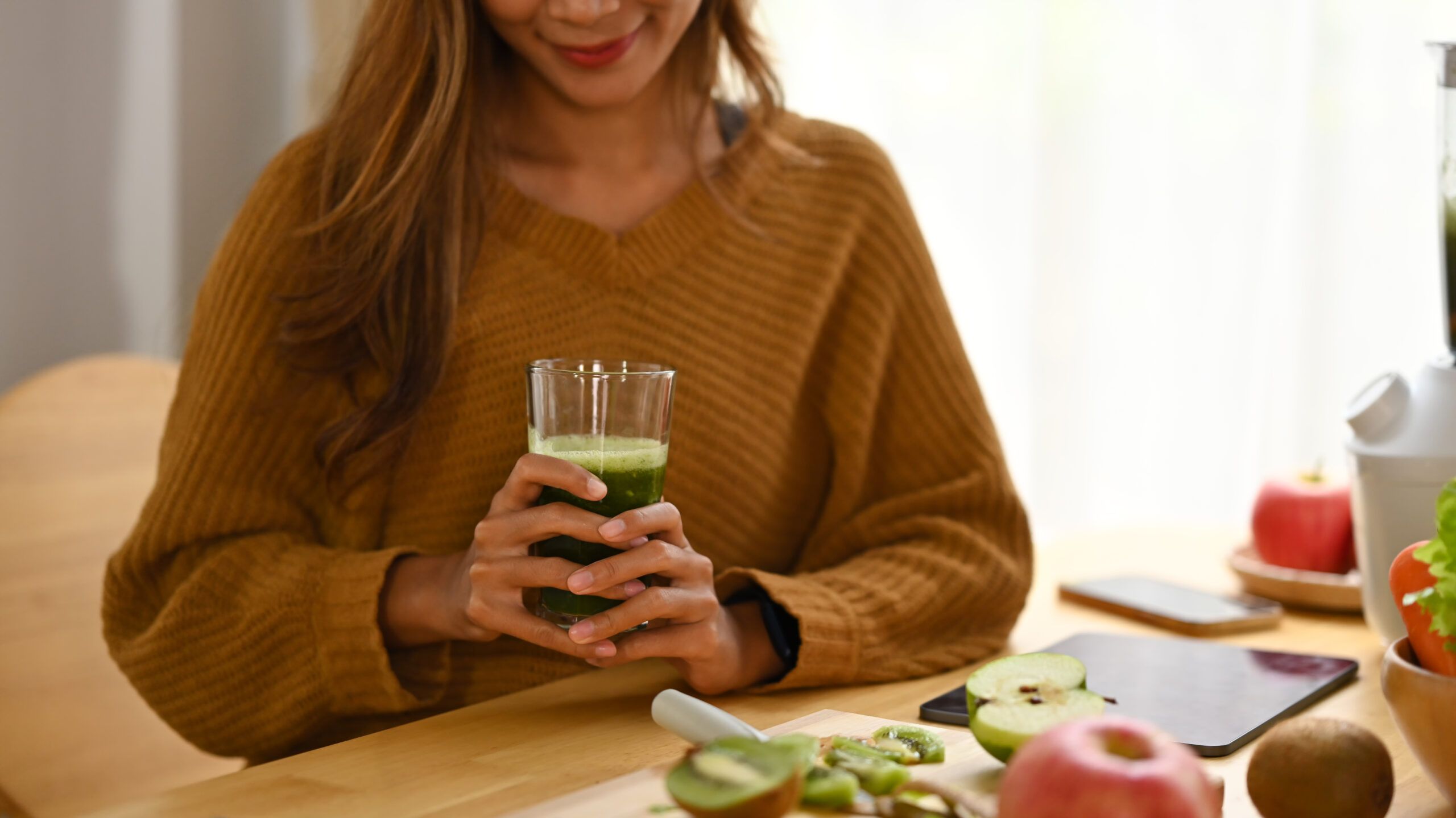 smiling young woman holding glass of healthy green 2024 11 27 03 36 19 utc
